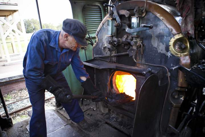 Bennett Brook Railway - a volunteer fires up the steam train