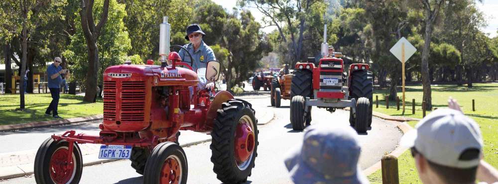 The Tractor Parade near the Village Junction Station with onlookers