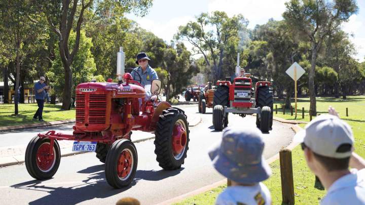 The Tractor Parade near the Village Junction Station with onlookers