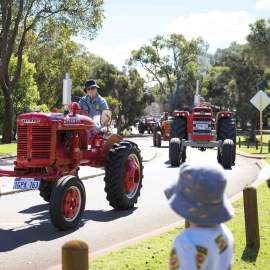 The Tractor Parade near the Village Junction Station with onlookers