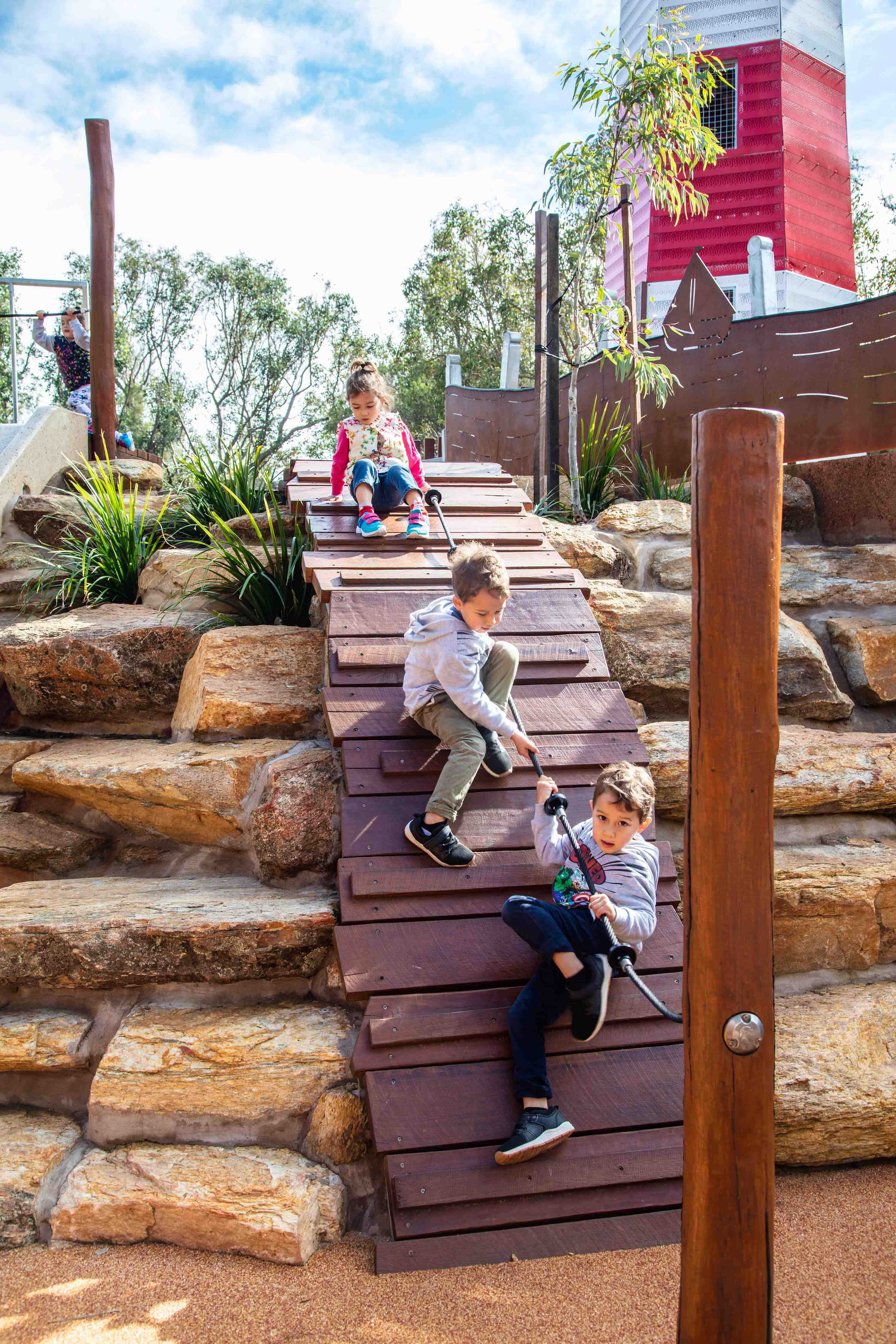 Pias Place kids climbing the base of the tower