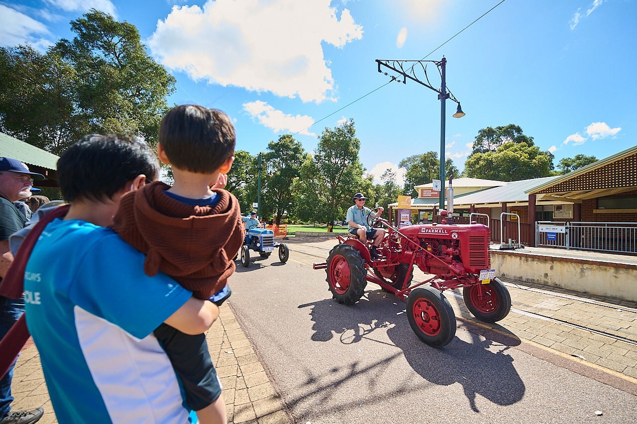 The Tractor Parade travels through the Village Mall, alongside the Visitor Information Centre