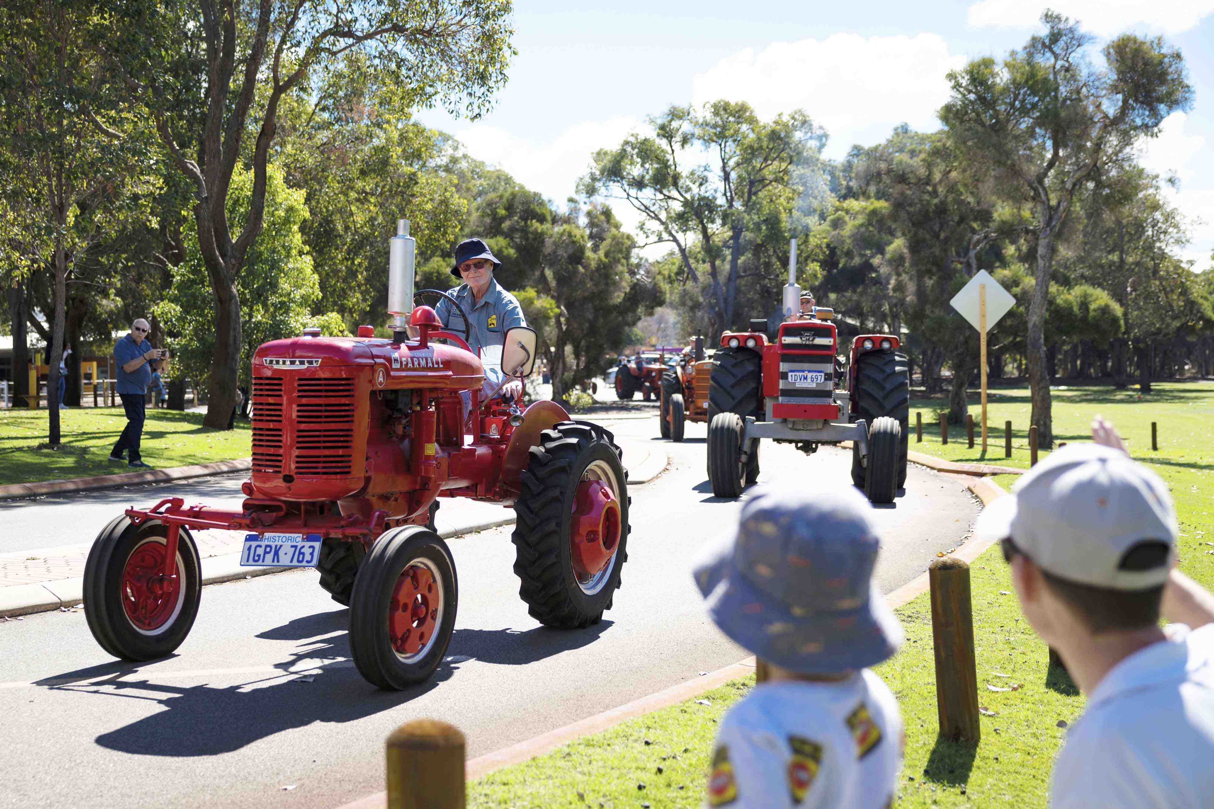 The Tractor Parade near the Village Junction Station with onlookers