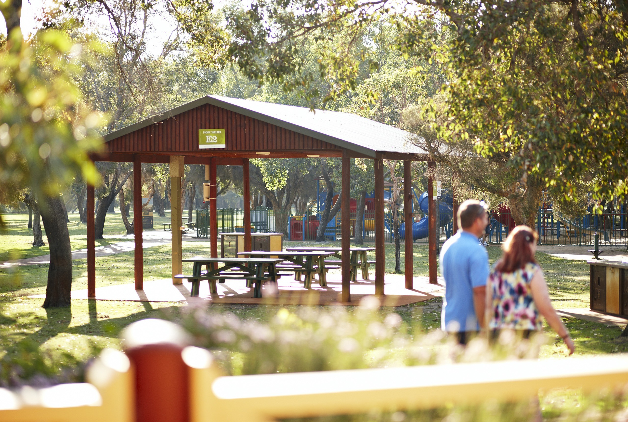 Hire facilities - shelters - couple walking past E2